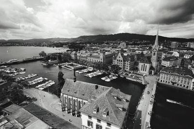 River in city against cloudy sky