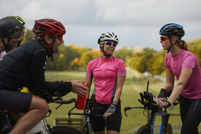 Smiling cyclists talking together