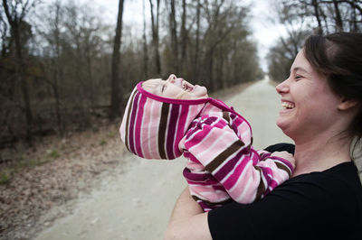 Side view of cheerful mother and daughter