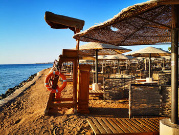 Built structure on beach against clear sky