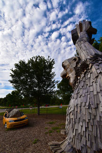 Old sculpture on land against sky