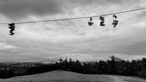 Low angle view of overhead cable cars against sky