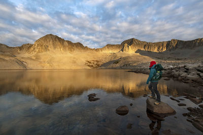 Full length of man standing in lake against sky