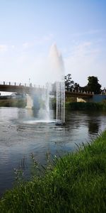 Water splashing in fountain against sky