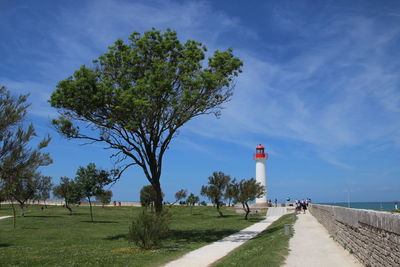 Lighthouse against blue sky during sunny day