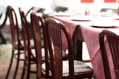 Close-up of empty chairs and table arranged in restaurant