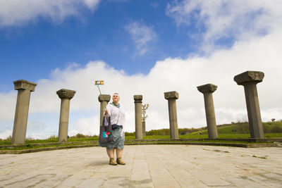 Full length of senior man standing against sky