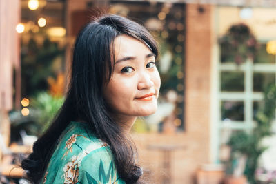 Portrait of beautiful young woman standing outdoors