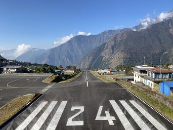 High angle view of road by mountains against sky