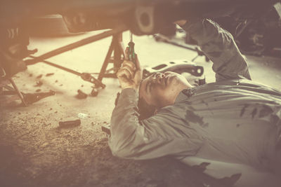 Mechanic repairing car at garage