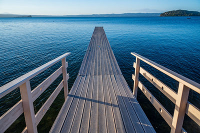 Wooden pier on the bolsena lake near marta, in province of viterbo, lazio, italy