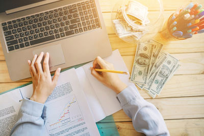 High angle view of person using laptop on table