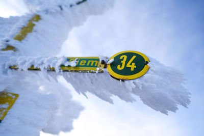 Information sign against sky