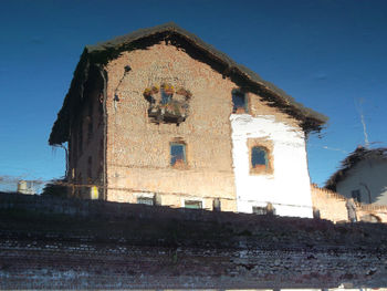 Low angle view of bell tower against sky