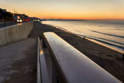 Pier over sea against sky during sunset