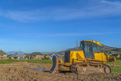 Construction site on field against blue sky