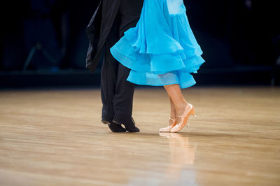 Low section of couple dancing on floor