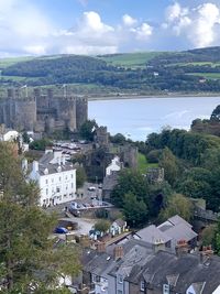 High angle view of townscape by sea against sky