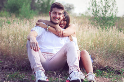 Portrait of young couple sitting outdoors