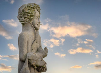 Low angle view of statue against sky