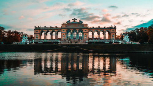 Reflection of building in lake at sunset