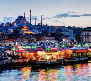 Boats in river with buildings in background