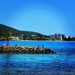 Scenic view of sea against clear blue sky