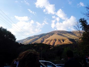 Scenic view of mountains against cloudy sky