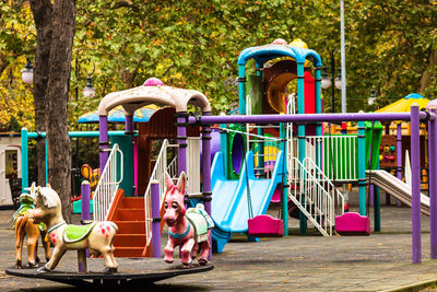 Outdoor play equipment against trees