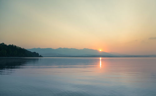 Scenic view of lake against sky during sunset