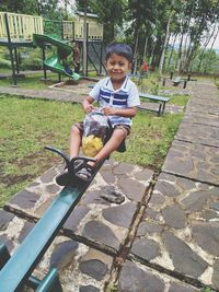 Portrait of boy sitting outdoors