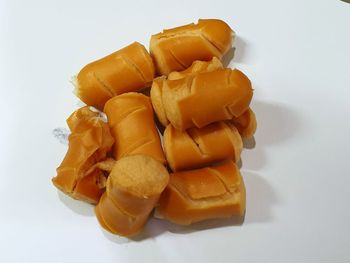 High angle view of chopped orange against white background