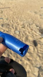 Person holding umbrella on beach