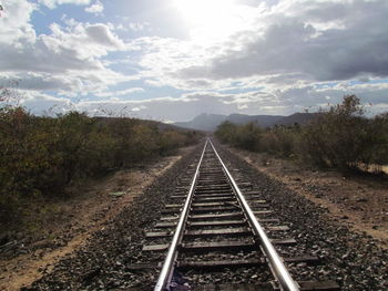 View of railway tracks against cloudy sky