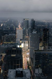 High angle view of illuminated buildings in city against sky