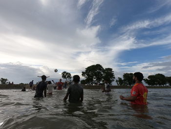 People on beach against sky