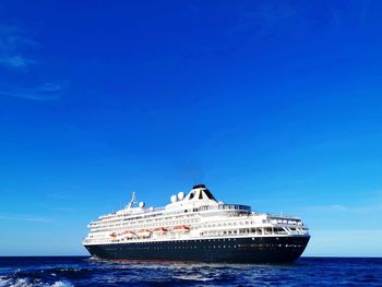 Ship in sea against blue sky