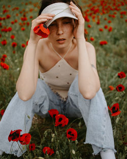 Rear view of woman holding yellow flower