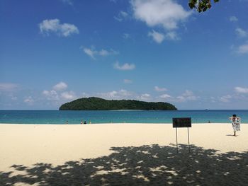 Scenic view of beach against blue sky