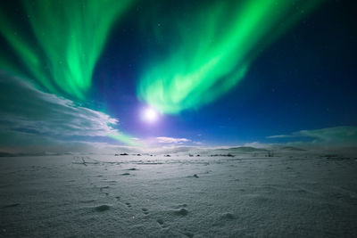 Scenic view of landscape against sky at night