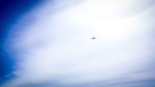 Low angle view of airplane flying in sky