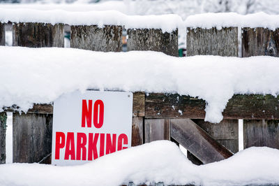 Close-up of text on board over snow field