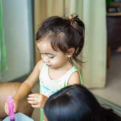 Child injecting organic fertilizer into small containers. fine motor skills activities for kids.