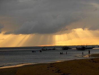 Scenic view of beach against sky during sunset