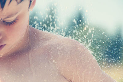 Close-up of shirtless boy during rainy season