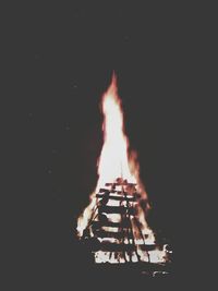 Bonfire against clear sky at night