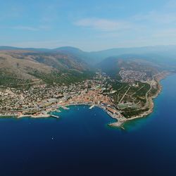 High angle view of buildings by sea against sky