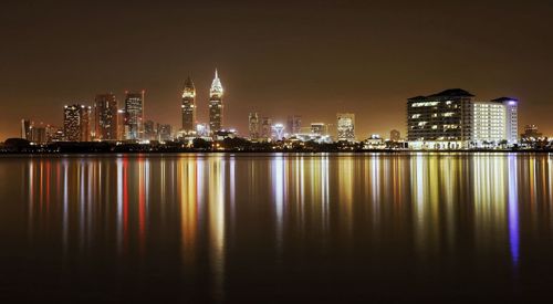 Scenic view of illuminated buildings against sky at night