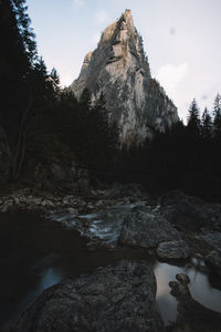 Scenic view of river by mountain against sky