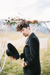 Side view of man holding guitar